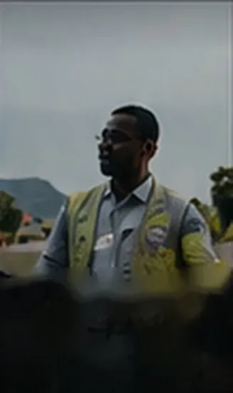 A man in a high-visibility vest outdoors